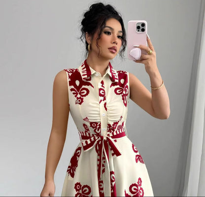 Woman wearing Orchid Moda Soho Stroll shirt dress with red floral print and sleeveless design taking a mirror selfie