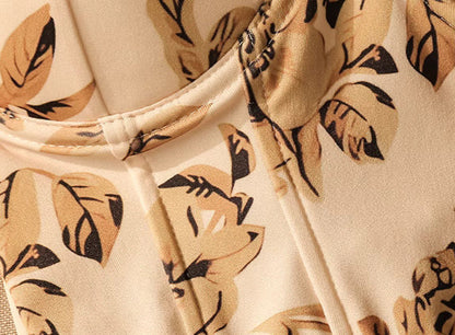 Close-up of Orchid Moda trendy ruffle cami top fabric with beige and black leaf print